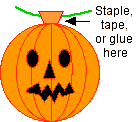 Attaching a string to the pumpkin.
